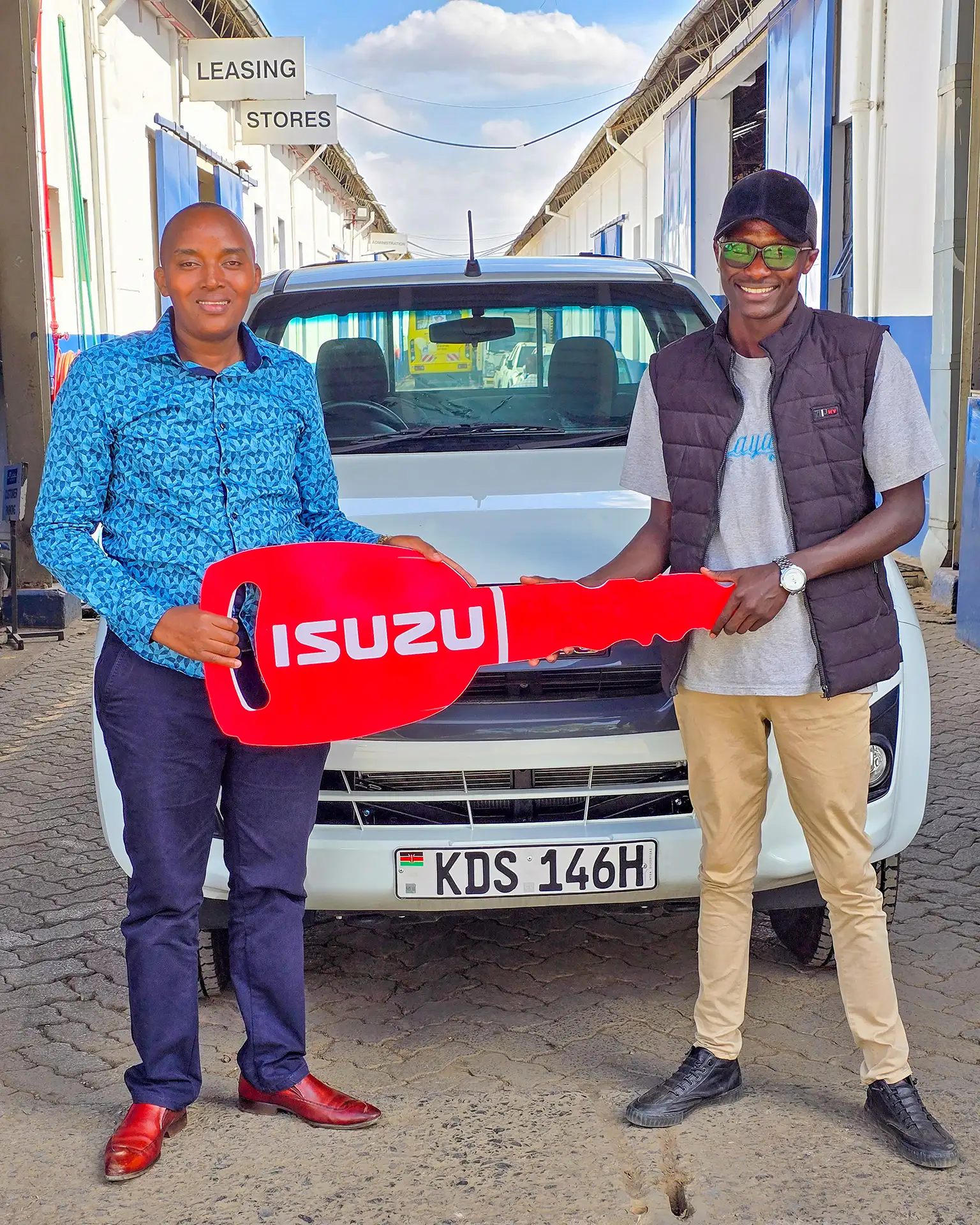 Top Isuzu sales representative handing over a D-Max Single Cab Pick-up to a satisfied customer in Kenya, showcasing excellent service and quality vehicles.
